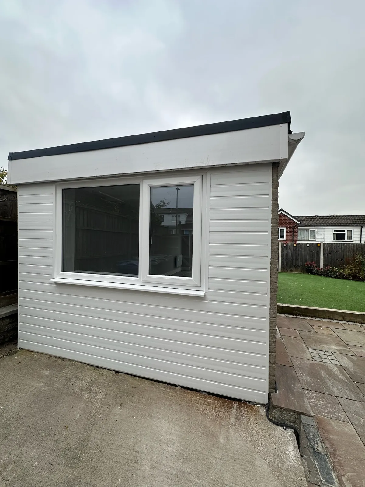 A new front wall and window in place of a garage door, built by the Convert Your Garage team.