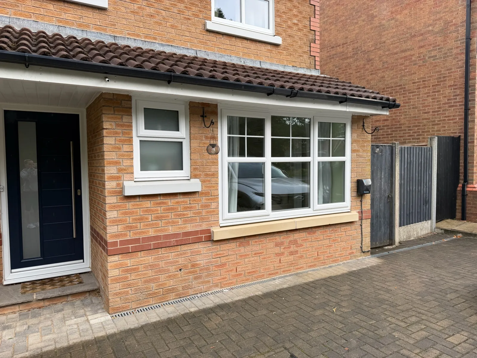 A completed garage conversion front with a new window and brickwork by the Convert Your Garage team.